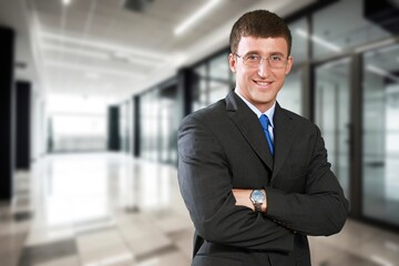 Smiling confident business man with crossed arms