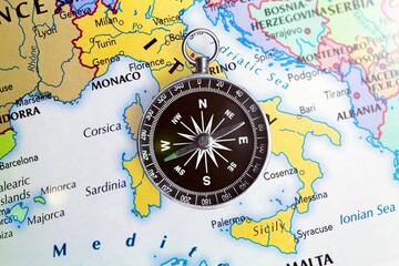 Magnetic old retro compass on world map.