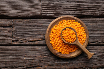Lens culinaris - Organic red lentils in bowl and spoon.