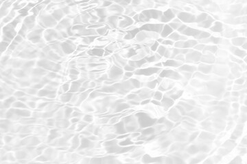 White water with ripples on the surface. Defocus blurred transparent white colored clear calm water surface texture with splashes and bubbles. Water waves with shining pattern texture background.