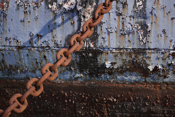 Old metal chain used to moor large boats rusting in the salty sea air