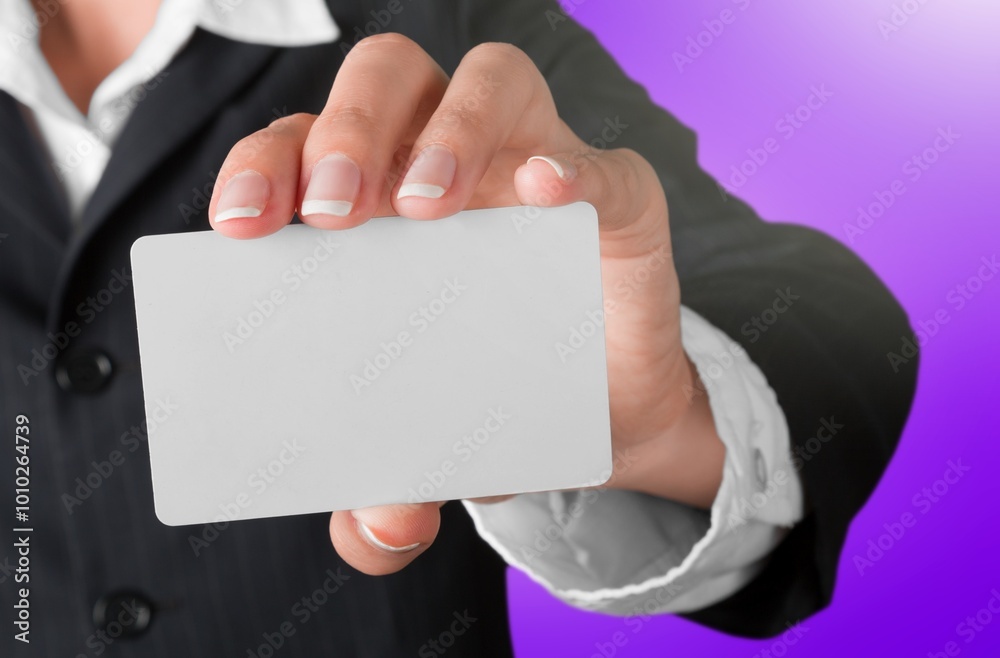 Wall mural Hand holding blank credit card on background.