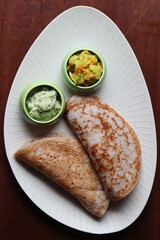 Ragi Set Dosa, Songy soft pancake, , dosa made with fermented batter of finger millet, rice and lentils, south Indian food served with coconut chutney and pototo curry (aloo masala)