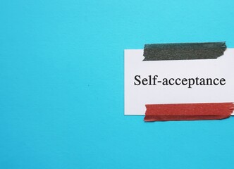 Note stick on copy space blue background with text Self-acceptance - ability to accept both your...