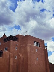 Adobe building against cloudy blue sky