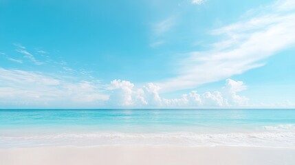 A beautiful blue ocean with a few clouds in the sky