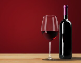 Bottle and glass of alcohol red wine on wall background.