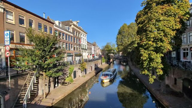 Utrecht, the Netherlands. 22 september 2024. Canal &ldquo;de Oudegracht&rdquo; with a tour boat sails through the canal in Utrecht and historic buildings in the background.