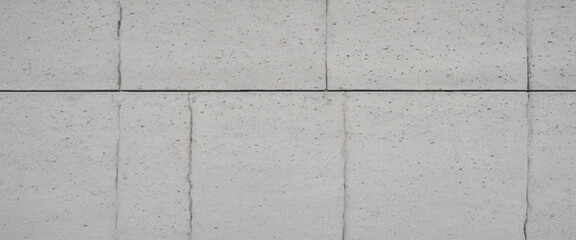 Fototapeta premium Modern style background and cement wall texture. white cement cinder block wall texture - background. Panorama of White Granite Exterior Wall Tiles Pattern with Smooth Surface texture and background. 