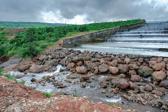 Water flows down the Jagmin step dam near Satara India at the end of the monsoons. Monsoon is the annual rainy season in India from June to September.
