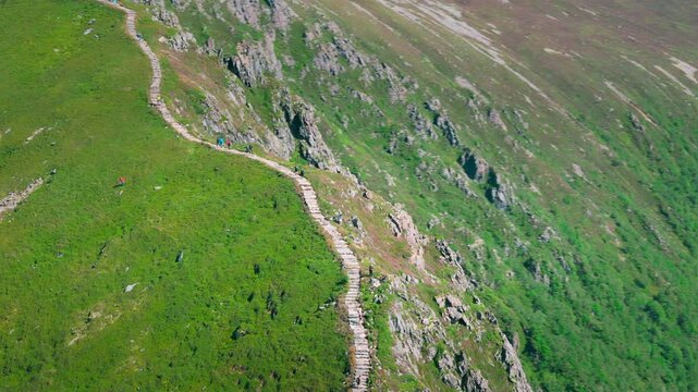 Aerial establishing shot of a people hiking up the famous Midsundtrappene