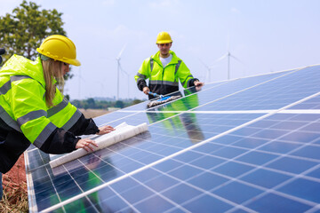 Caucasian woman engineer technician reading blueprints on solar panels