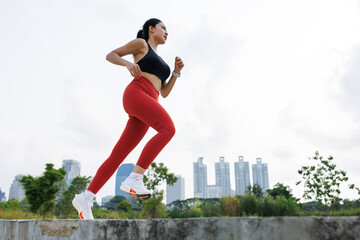 woman running jogging in park outdoor in city center