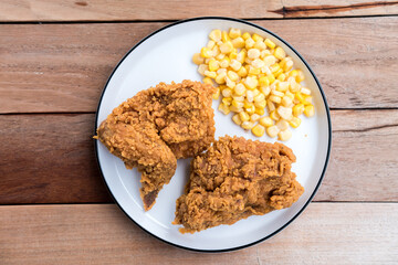 Typical fast food fried chicken (wings) with steamed corn, a food rich in protein, fiber and carbohydrates.
diet concept