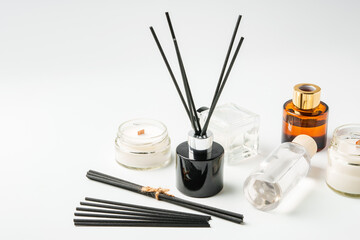 Aromatic essentials including scented candles, incense sticks, and diffusers arranged on a light background