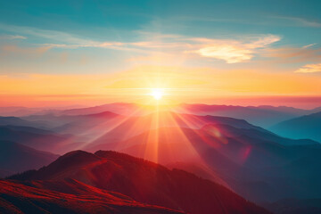 The sun is setting over a mountain range, casting a warm glow over the landscape