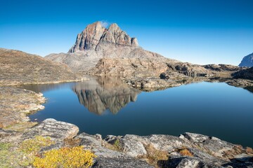 Mountains and lake in Uummannaq during summer time, Greenland. Located on an island. Beautiful arctic landscape. View of the Greenlandic island of Uummannaq with its distinctive rock.