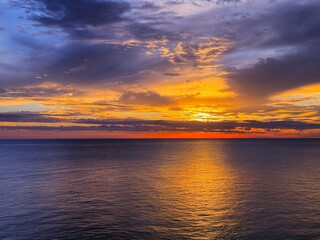 Colorful sunset sky clouds and calm sea at evening.