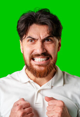 A man expresses intense frustration with a furious gesture against a bright green backdrop
