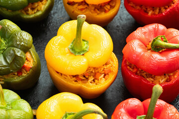 Baked stuffed pepper ( paprika ) with rice , carrot and meat . Top view on rustic background