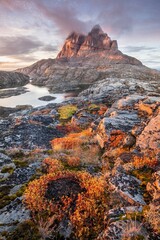 Mountains and lake in Uummannaq during summer time, Greenland. Located on an island. Beautiful arctic landscape. View of the Greenlandic island of Uummannaq with its distinctive rock.