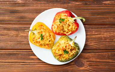 Baked stuffed pepper ( paprika ) with rice , carrot and meat . Top view on rustic background