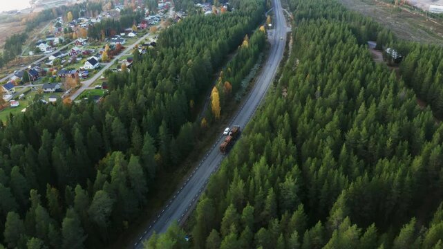 White Car Traveling on Road Surrounded by Trees and Suburbs in Pite&aring;, Northern Sweden
