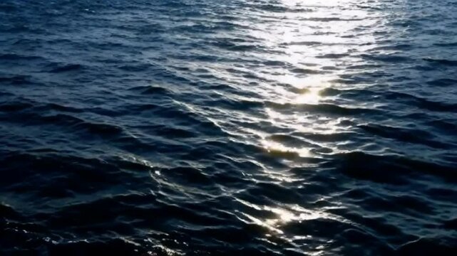 Sun rays illuminating the rough sea surface during turbulent afternoon