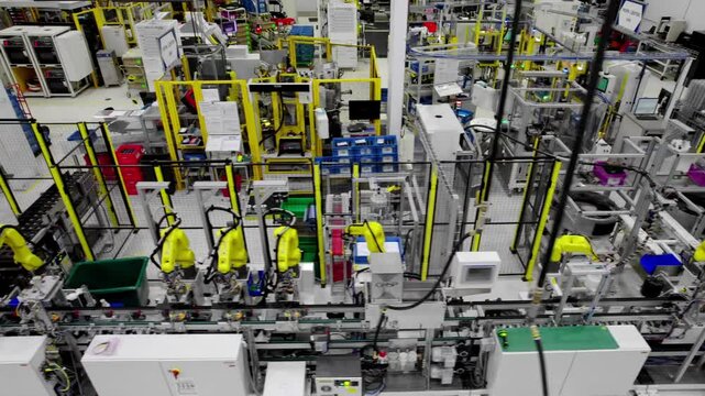 Advanced modern machinery in tech factory, wide high angle slide shot