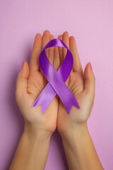 Close up of hands holding purple ribbon on pink background. Cancer symbolic awareness concept. World Alzheimer's day. World cancer day. International epilepsy day.
