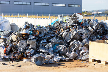 Scrap metal pile of automotive and industrial components at recycling facility