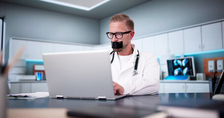 Medical Doctor With Black Duct Tape Over His Mouth