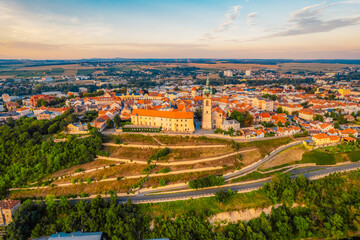 Melnik Castle on the hill above Labe and Vltava River in sunny day.  Church with city space and square. Czech Republic.
