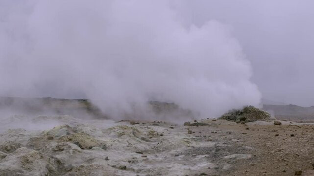 Thick clouds of hot steam rise from a geothermal landscape at Namaskaro in Iceland