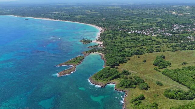 Lagoon and bay of playa Coquitos during sunny day. Beautiful coastline of tropical island and clear Caribbean Sea. Aerial Birds Eye flight.