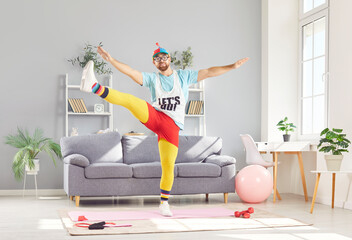 Funny man in a retro sports sportswear is engaging in a stretching exercise at home. His workout includes aerobic moves, showcasing a unique approach to fitness and sport in a home gym setting.