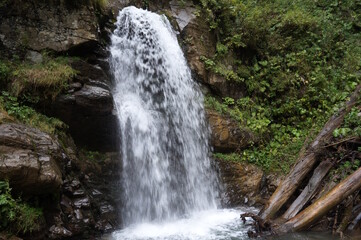 A beautiful waterfall in a mountainous and wooded area. Mendelikha Park.