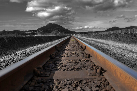 Narrow gauge railway train track on a restored vintage railway line in Porthmadog, Wales, United Kingdom