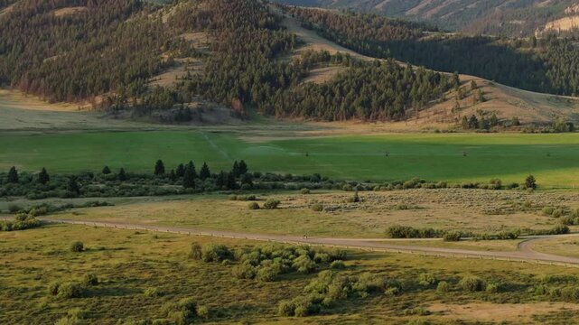 Scenic view of Sunlight Basin's green fields and rolling hills along Beartooth Highway, Wyoming
