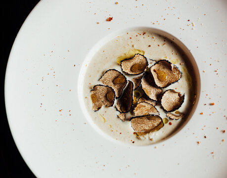 Top view of food styling on truffle soup in white soup bowl plate 