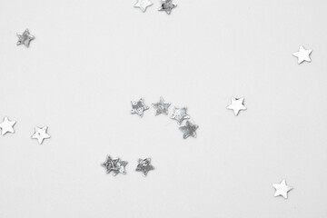 sparkles silver stars on white background with text place- Image