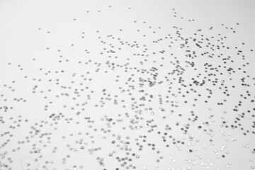 sparkles silver stars on white background with text place- Image