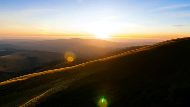 Sunrise over rolling hills with lengthening shadows and soft light transitions