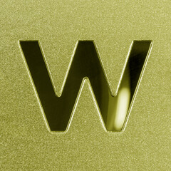 Letter W on a golden grained shiny metal surface. English alphabet.