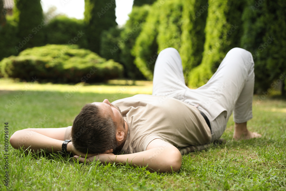 Canvas Prints Man resting on green lawn in park