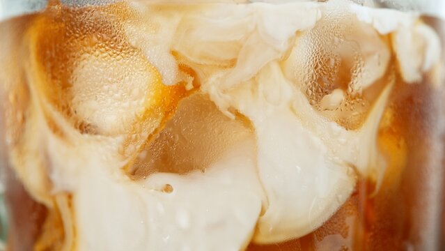 Macro Shot of Pouring Milk into Ice Coffee, Close-up