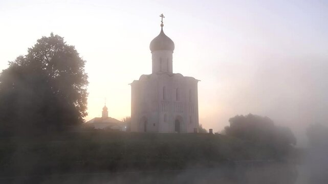 The ancient Church of the Intercession on the Nerl in the morning September fog (timelapse). Bogolyubovo, Russia