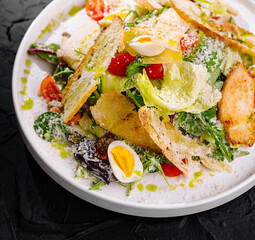 Fresh caesar salad on dark background