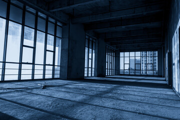 Expansive Empty Industrial Space with Natural Light and Shadows