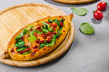 turkish pide lying on wooden boards